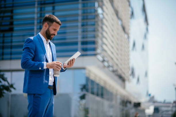 istock Businessman working on digital tablet on a coffee break 1073023896