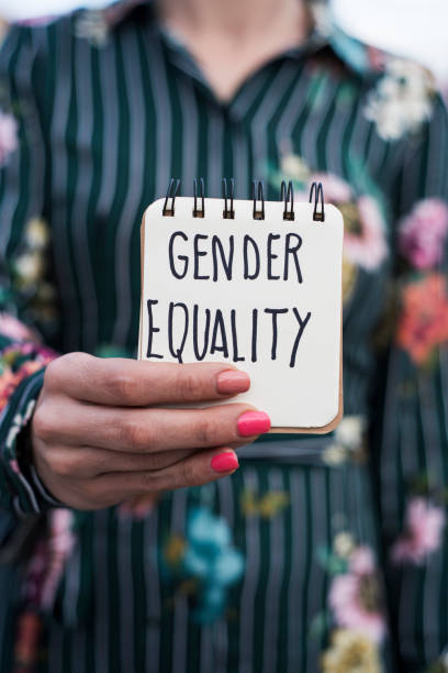 istock woman shows notepad with the text gender equality 1073024720