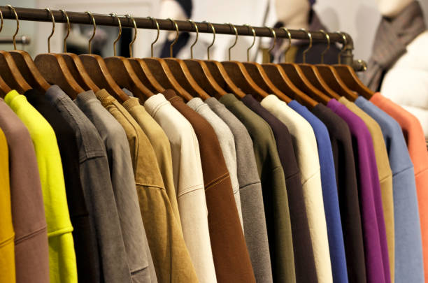 istock Multicolored outerwear hanging on hangers in the store close-up, side view 1073028534
