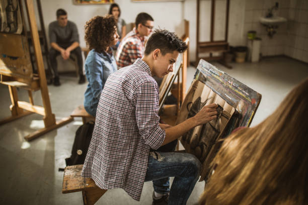 istock Group of art students drawing paintings at art studio. 1073028604