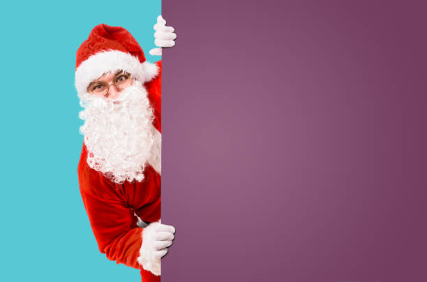 istock Santa Claus with colorful advertisement board 1073033792