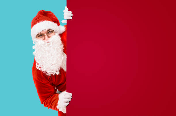 istock Santa Claus with colorful advertisement board 1073033830