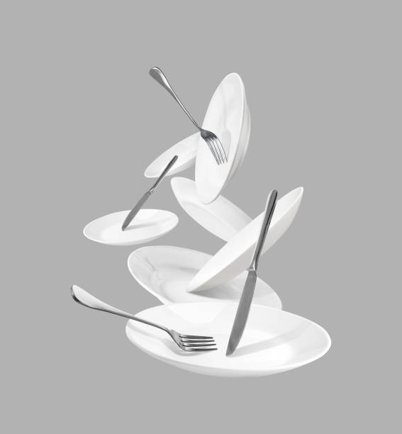istock White kitchenware with forks and knives isolated on gray background 1073035216