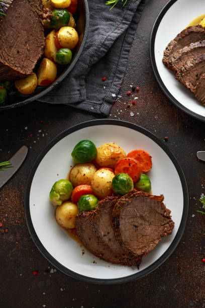 istock Sliced Roast beef with honey glazed vegetables, served on plate. festive dinner 1073038768