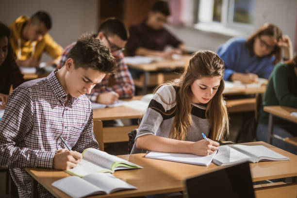 istock Group of high school student writing an exam in the classroom. 1073039892