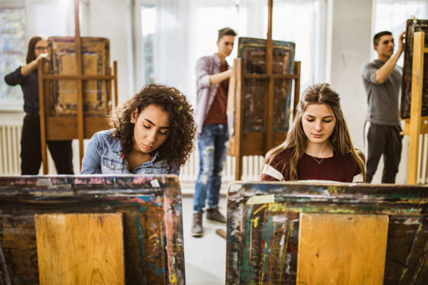 istock Group of students making their paintings on a class at art studio. 1073040722