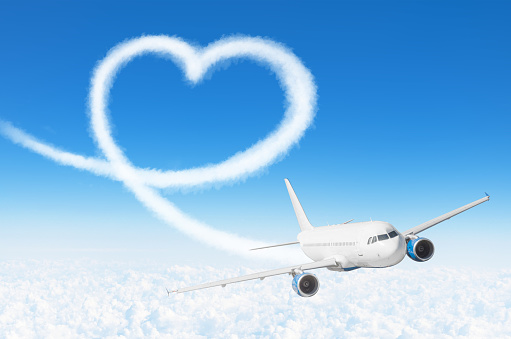 Love heart cloud drawing by airplane. Love concept for traveling the world