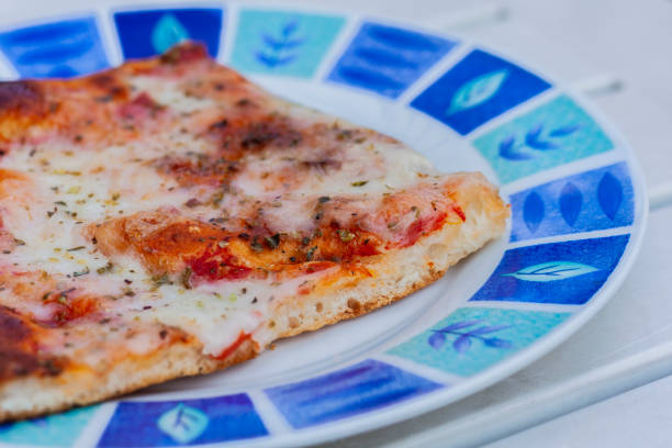 istock Pizza with ham, mozzarella, tomato sauce on the plate 1073044086