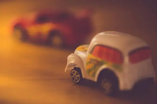 two toy cars taxi and sportcar in bright light