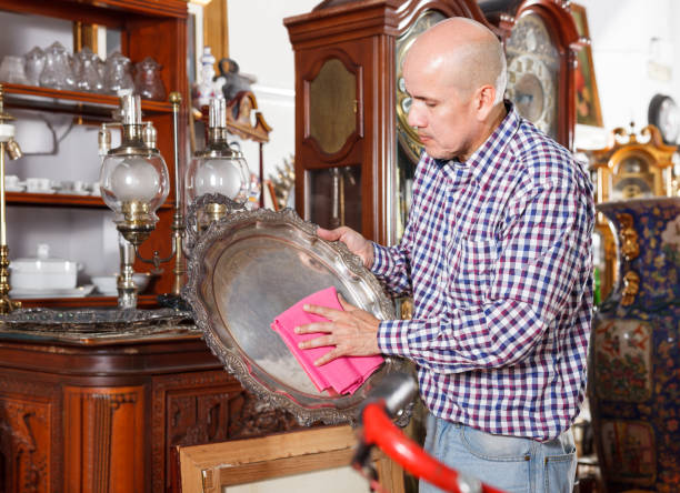 istock gentleman wiping dust on ancient items 1073048448