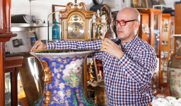 istock Interested elderly man measuring vintage amphora 1073048460