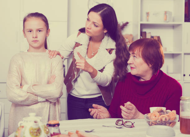 istock Offended little while mom and granny scolding her 1073052366