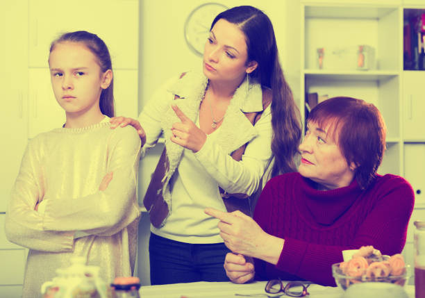 istock Offended little while mom and granny scolding her 1073052396