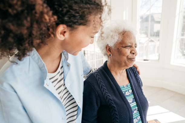 Home care for seniors A woman providing home care to a senior adult. caregivers day stock pictures, royalty-free photos & images