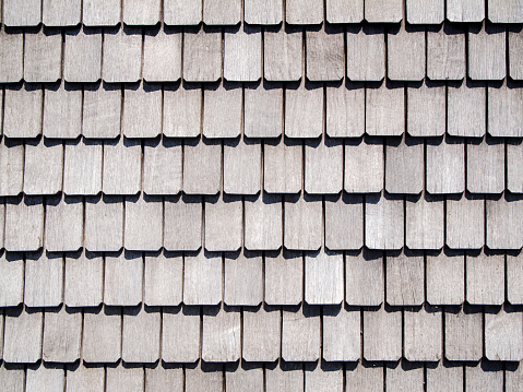 Full-frame view of weathered roof shingles.