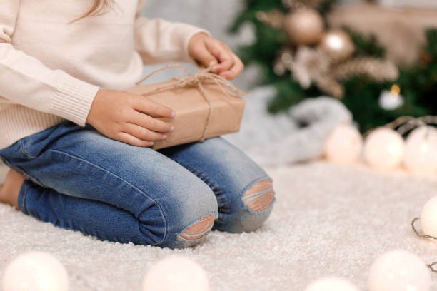 istock Child hands holding beautiful pink gift box 1073055604