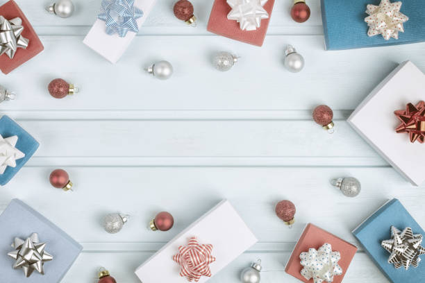 istock Christmas composition with copy space. In a circle of blue background are red and silver Christmas balls, gift boxes with bows. Festive layout with place for text. 1073057308