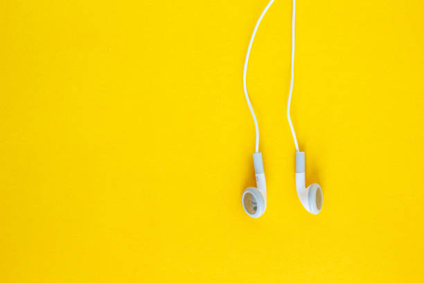 istock earbuds or earphones on yellow background 1073068526