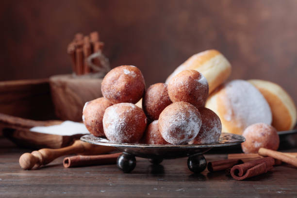 istock Sweet donuts with cinnamon sticks powdered with sugar. 1073069542