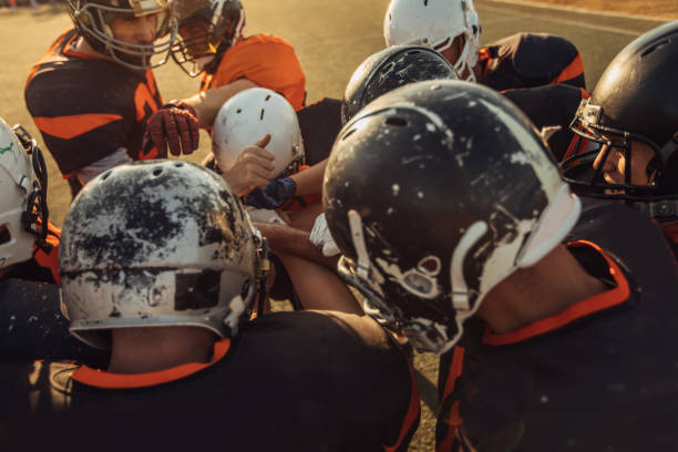 istock Football team holding hands 1073070850