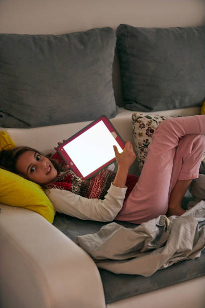 istock Little girl studying and doing homework at home with tablet. 1073071956