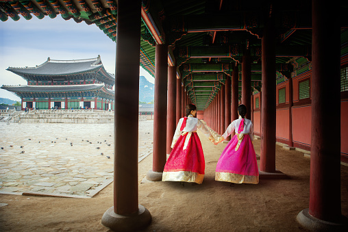 Korean lady in Hanbok or Korea gress and walk in an ancient town and Gyeongbokgung Palace in seoul, Seoul city, South Korea.