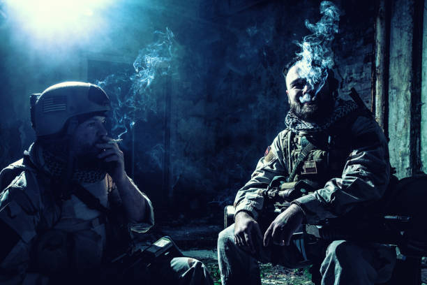 istock Tired commando soldiers smoking after intensive firefight 1073076444