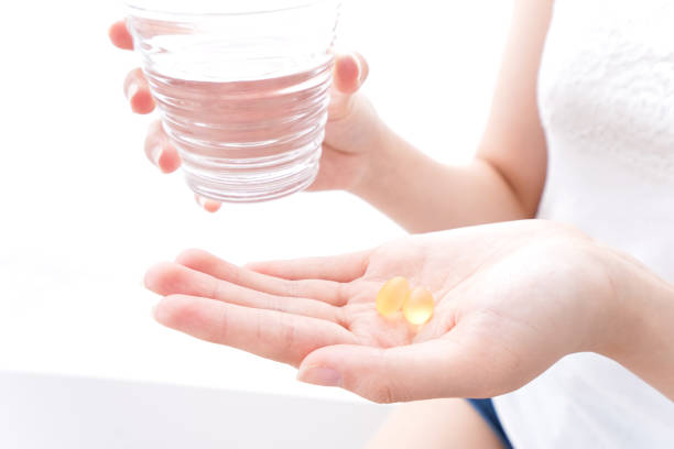 istock Young woman drink pills 1073077904