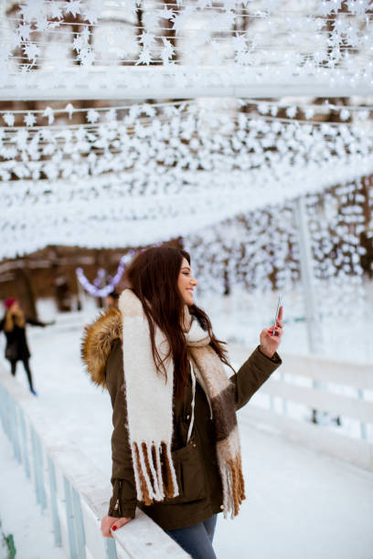 istock Young woman in winter park 1073085544