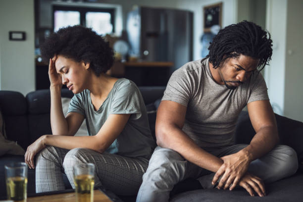 African American couple having problems in their relationship at home. Young black couple feeling sad after arguing on sofa at home. breaking up stock pictures, royalty-free photos & images