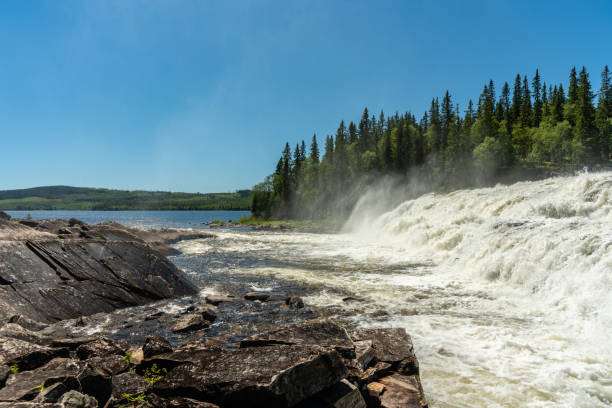 istock Waterfall with cascades of white flushing water and mist 1073090932