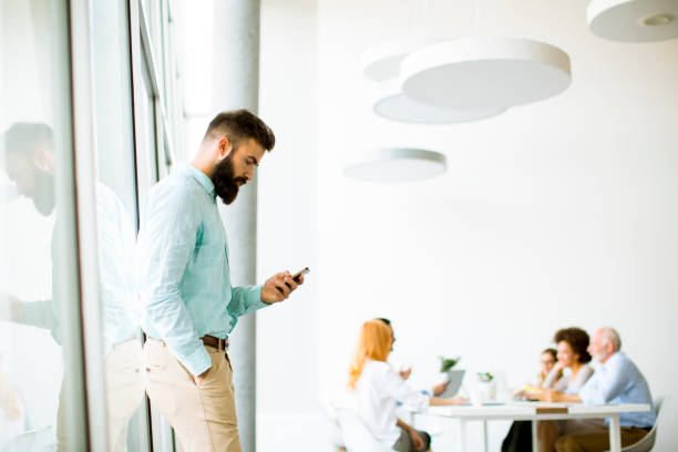 istock Young businessman using mobile phone in office 1073093388