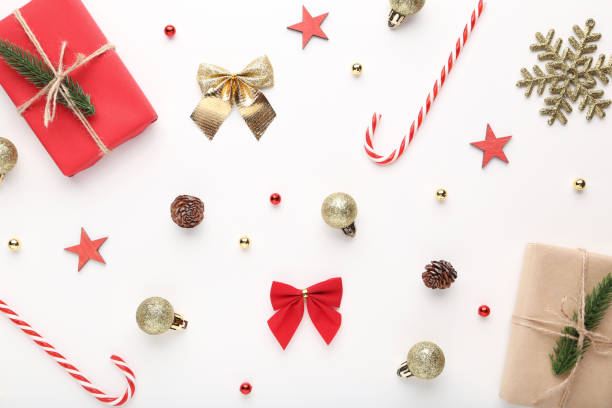 istock Gift boxes with candy canes and baubles on white background 1073093612