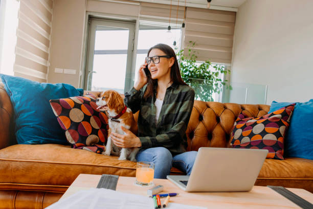 istock woman talking on her phone while working from home 1073094274