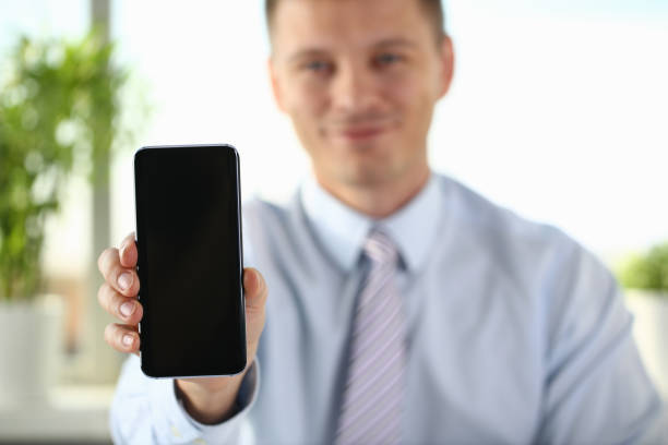 istock A businessman holds a new smartphone 1073095530
