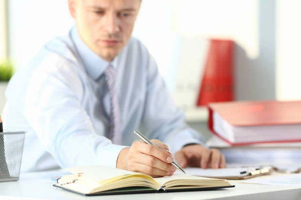 istock Male arm in suit and tie hold silver 1073095592