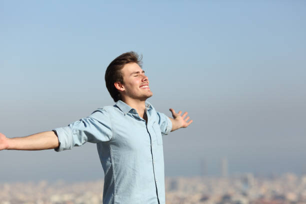 istock Happy man celebrating new day with urban background 1073096150