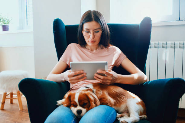 istock woman enjoying at home with her dog 1073096502