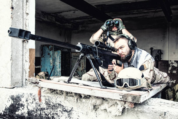 istock Sniper team with large caliber rifle in ambush 1073098070