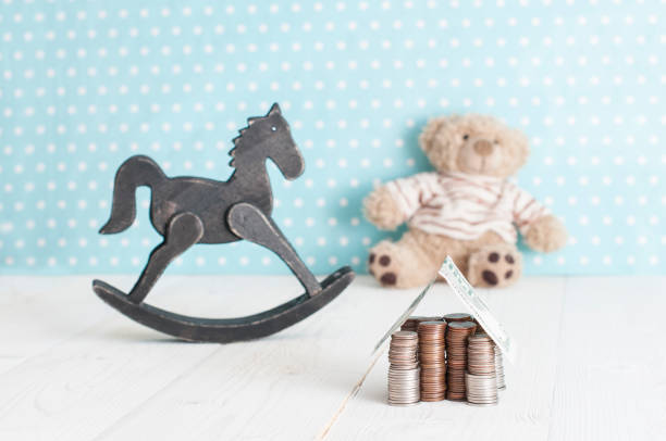 toy horse, teddy bear and money house stock photo