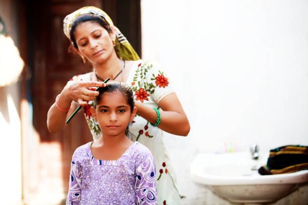 Rural women preparing her child for school in the morning.