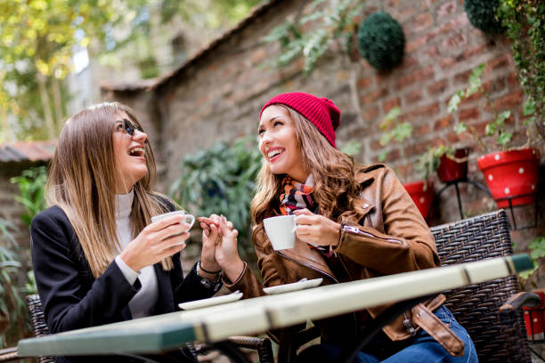 istock Two girlfriends are making fun in the cafeteria 1073119154