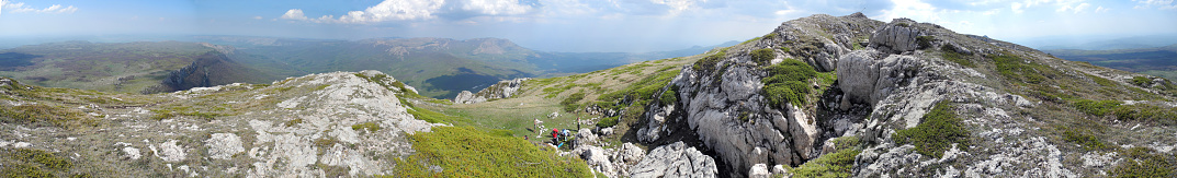 Panorama of rocky mountain ridge. Tourists made a halt. Crimean mountains