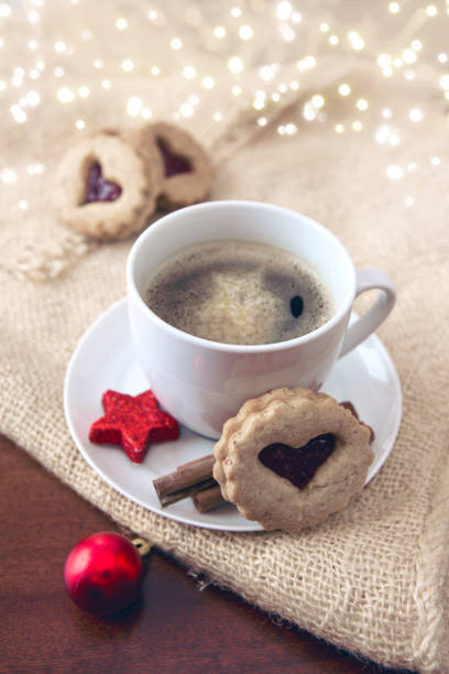 istock Christmas heart-shaped Cookie and coffee cup with red decoration. 1073121394