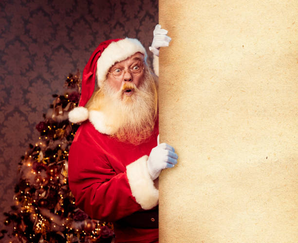 istock Santa Claus pointing on blank banner 1073122364