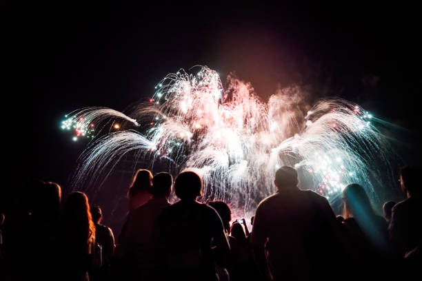 istock Crowd watching fireworks and celebrating new year eve 1073124864