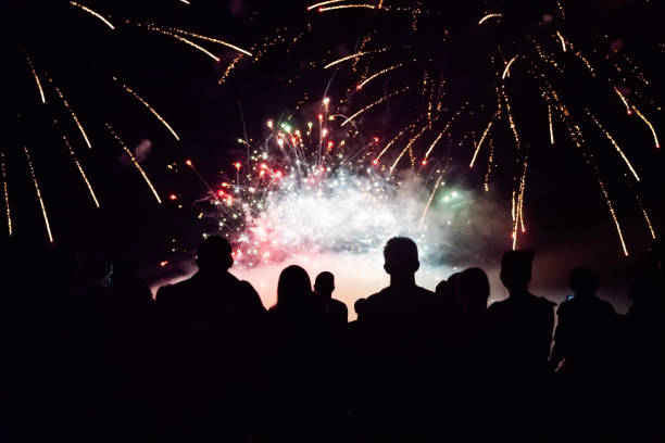 istock Crowd watching fireworks and celebrating new year eve 1073124986