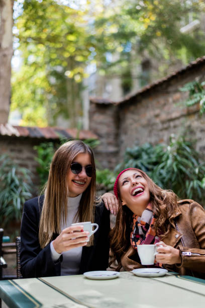 istock Two girlfriends are making fun in the cafeteria 1073130922