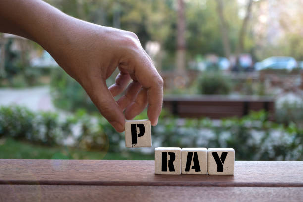 istock PRAY Concept with Hand and alphabet blocks 1073131930