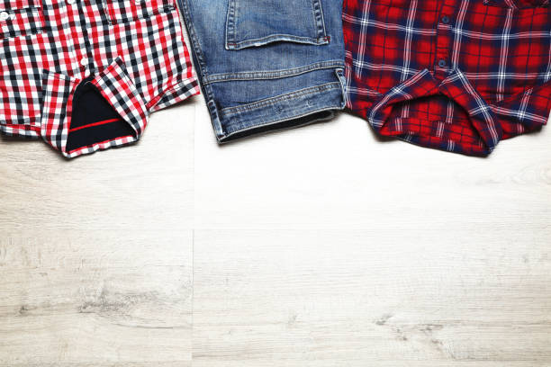istock Folded shirts and jeans on wooden table 1073137050